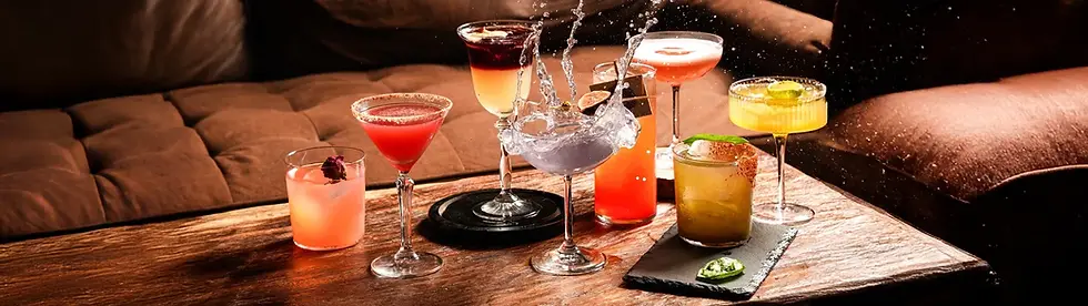 Selection of colorful cocktails for Amante bar on a wooden table
